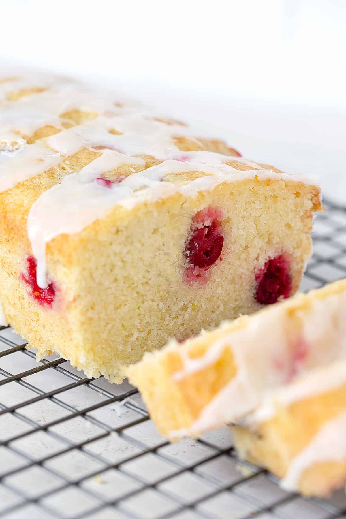 cranberry lemon loaf sliced on cooling rack