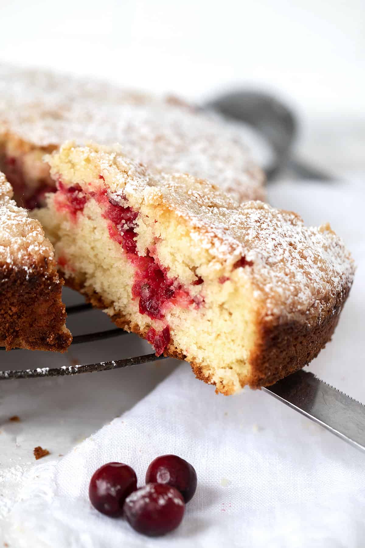 cranberry coffee cake, sliced on cooling rack