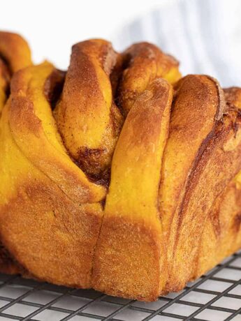 cinnamon swirl pumpkin yeast bread on cooling rack