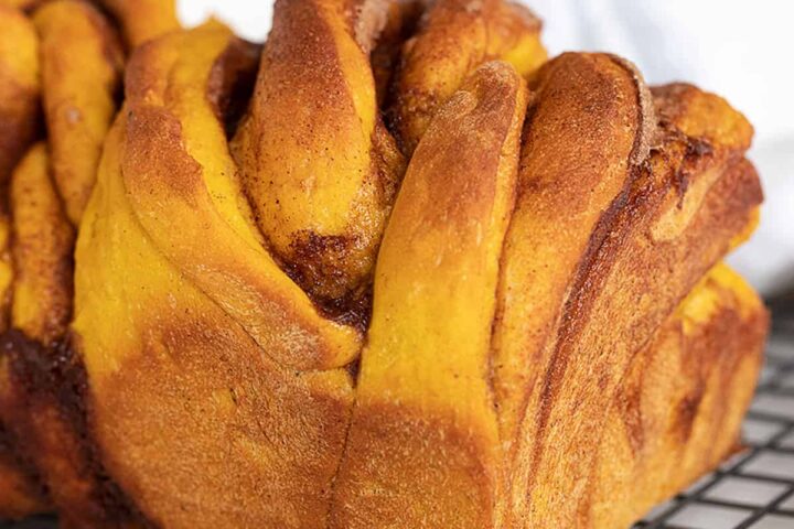 cinnamon swirl pumpkin yeast bread on cooling rack