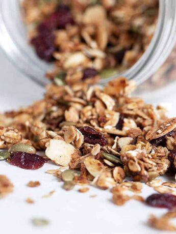 cranberry granola spilling out of jar