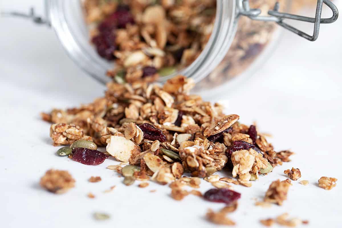 cranberry granola spilling out of jar