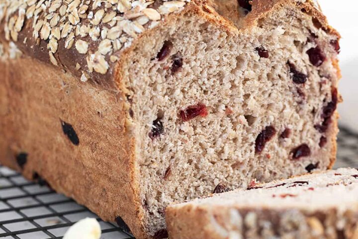 cranberry oatmeal bread sliced on cooling rack