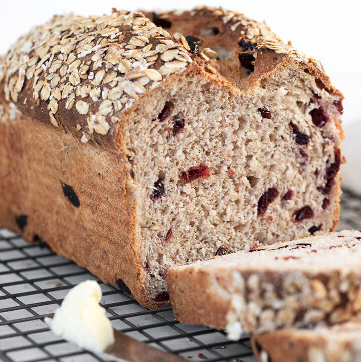 cranberry oatmeal bread sliced on cooling rack