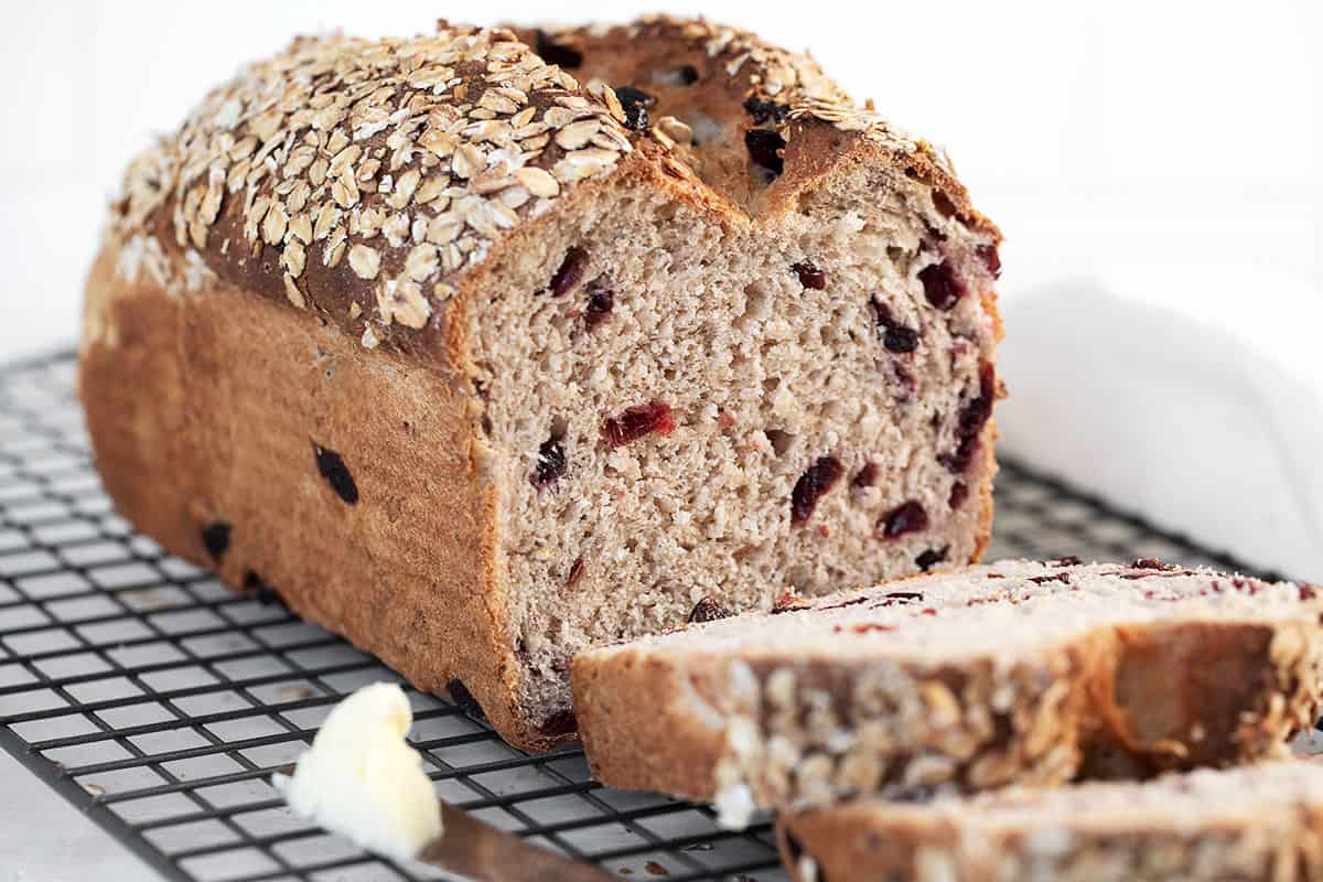 cranberry oatmeal bread sliced on cooling rack