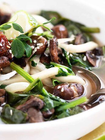 udon soup in bowl with spinach and mushrooms