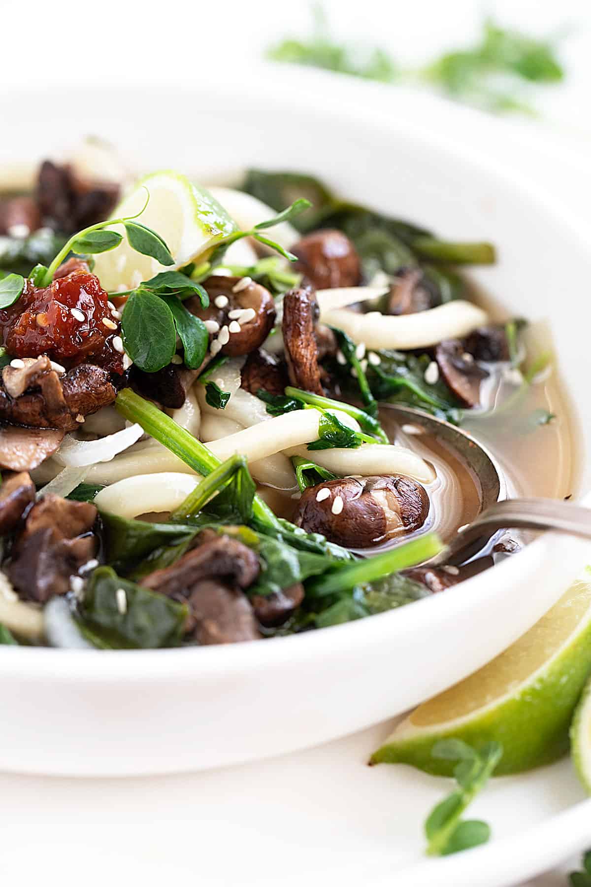 udon soup in bowl with spinach and mushrooms