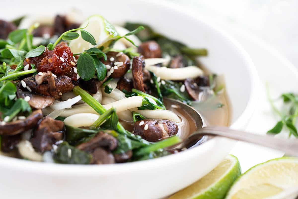 udon soup in bowl with spinach and mushrooms