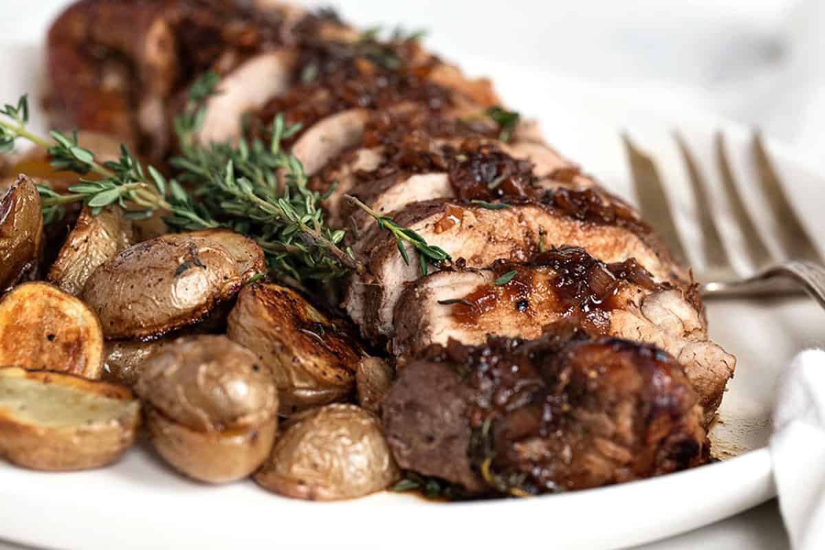 pork tenderloin sliced with fig balsamic sauce and roasted potatoes