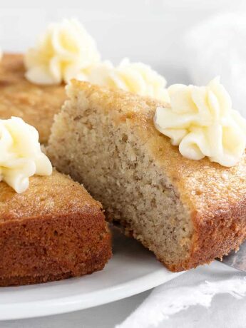 banana snack cake sliced with cream cheese frosting