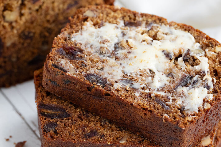 Date nut bread sliced and buttered.