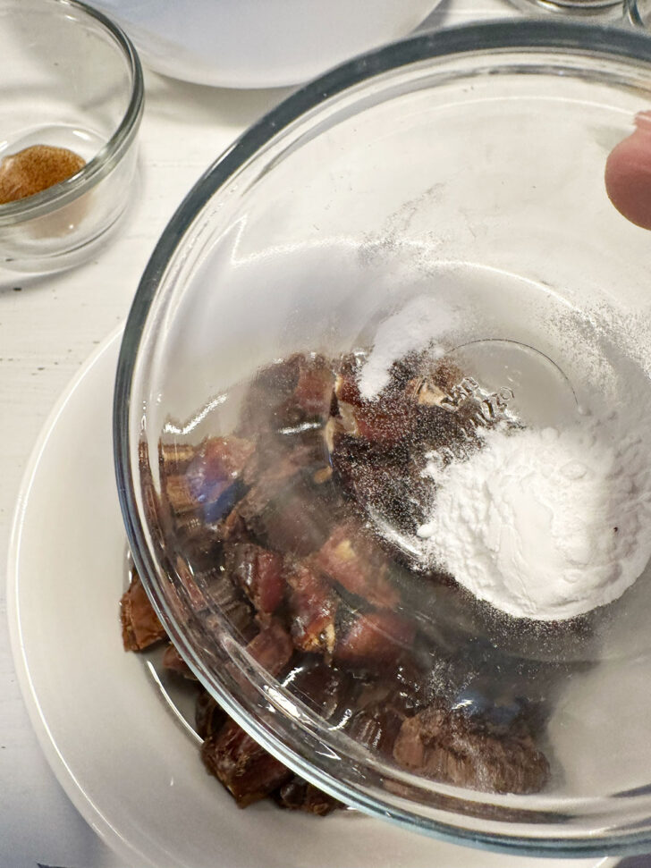 Adding baking soda to dates and boiling water.