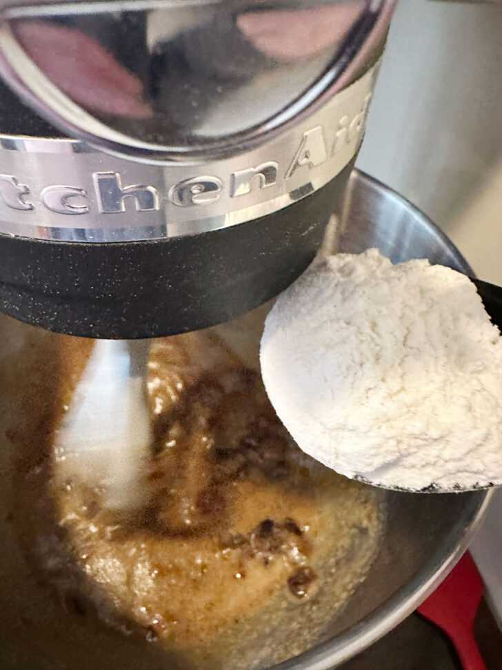 Adding flour mixture to batter.