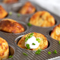 muffin tin mashed potatoes in muffin tin with sour cream and green onion
