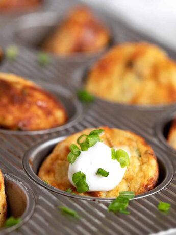 muffin tin mashed potatoes in muffin tin with sour cream and green onion
