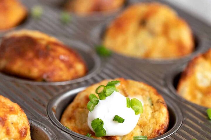 muffin tin mashed potatoes in muffin tin with sour cream and green onion