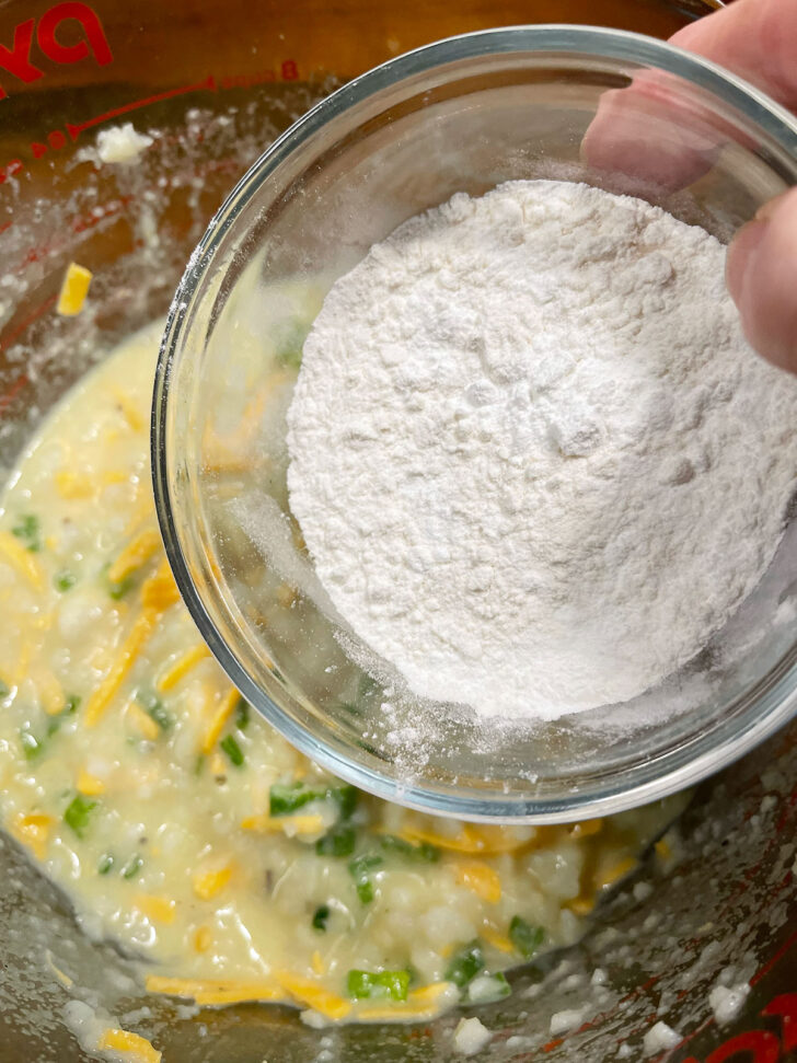 Adding flour to batter.