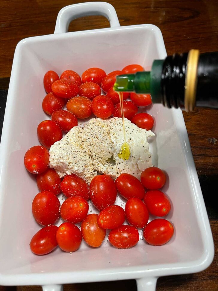 Cherry tomatoes and feta in casserole dish.