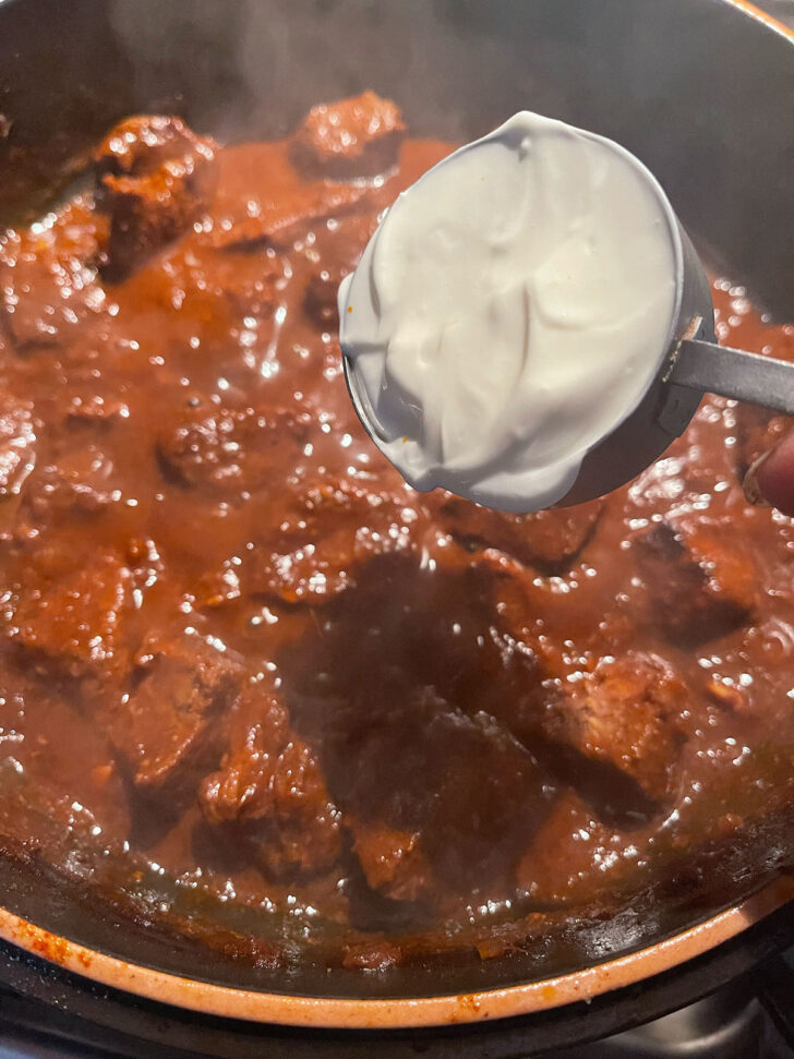 Adding sour cream to beef Paprikash.