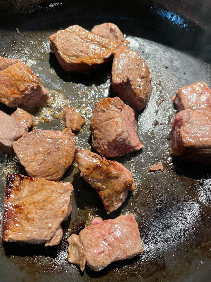 Browning beef in skillet.