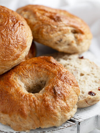 Cinnamon raisin bagels on serving board.
