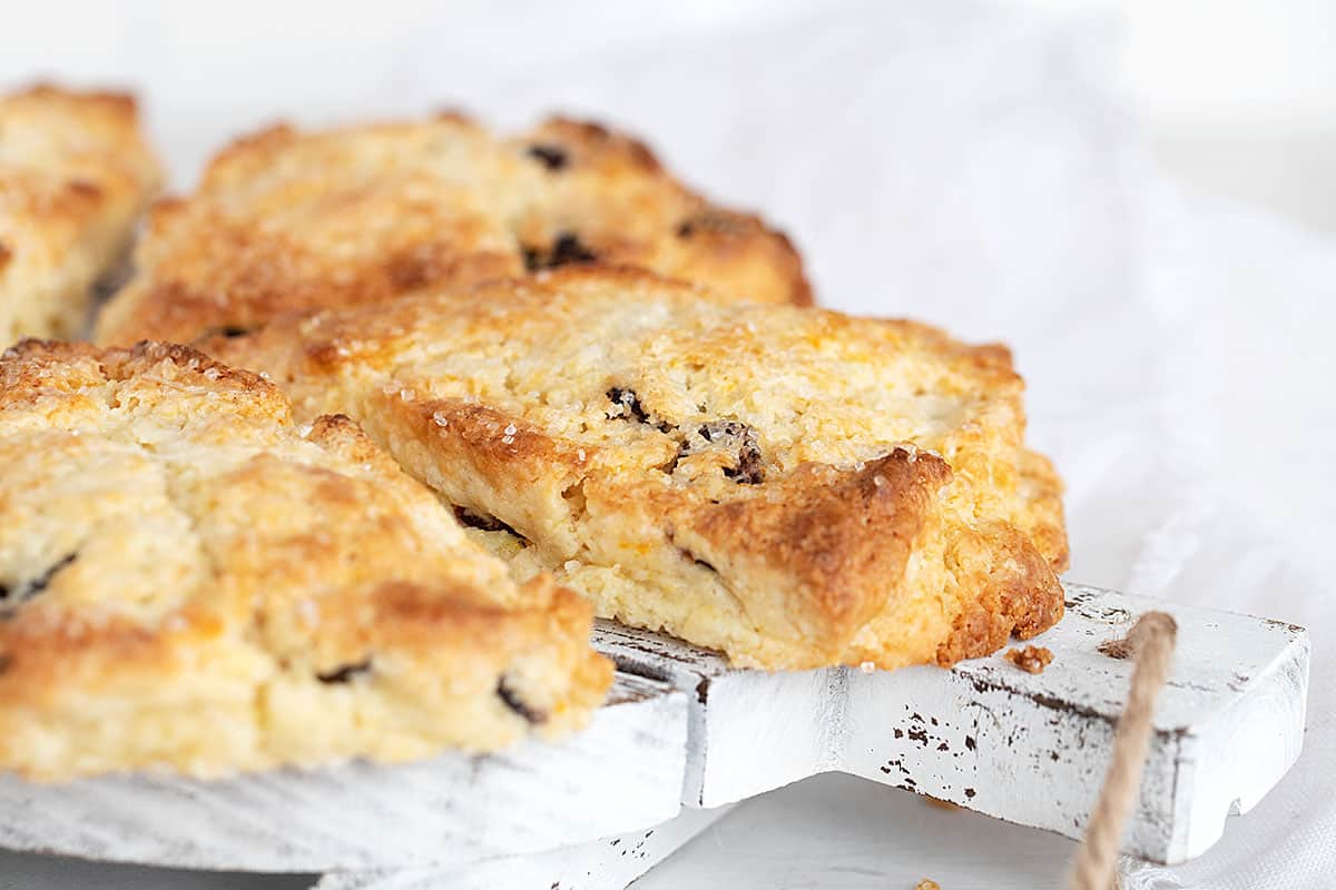 cranberry orange scones on wooden tray