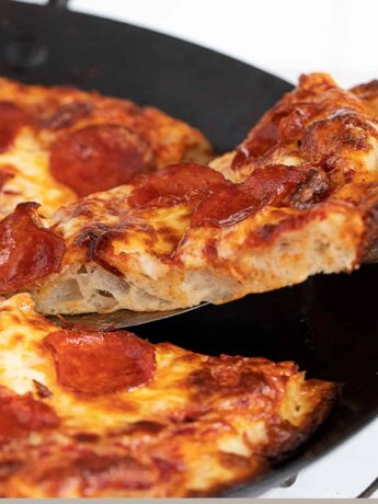 pan pizza sliced in pan
