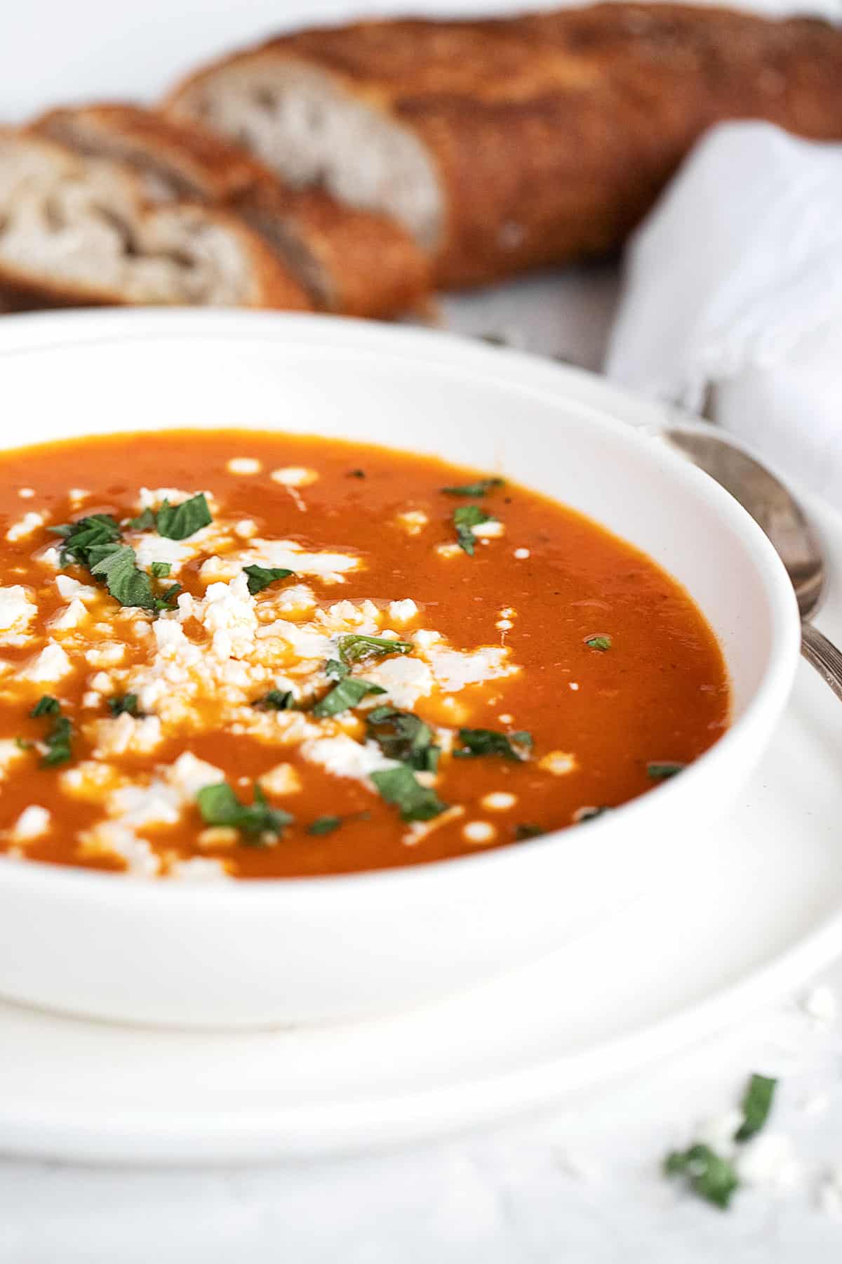 roasted red pepper and tomato soup in white bowl