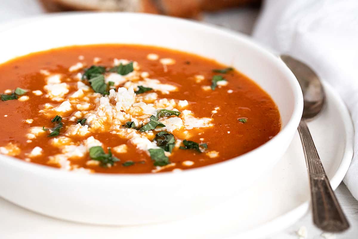 roasted red pepper and tomato soup in white bowl