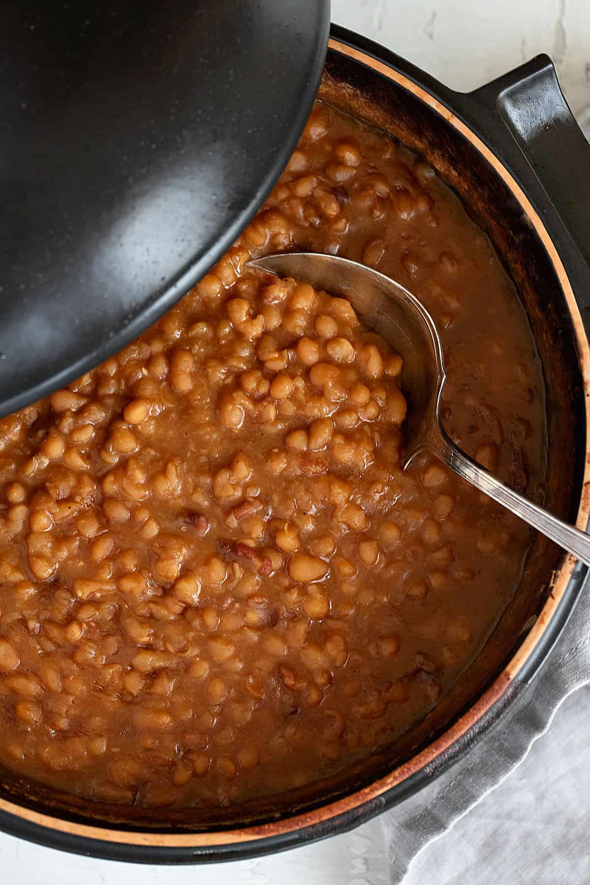 maple baked beans in pot with spoon