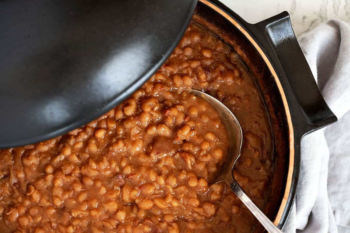 maple baked beans in casserole dish with spoon