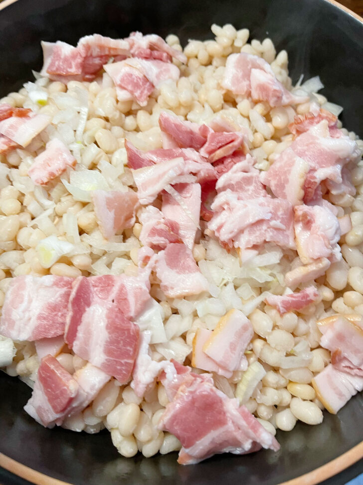 Bacon pieces on top of the beans.