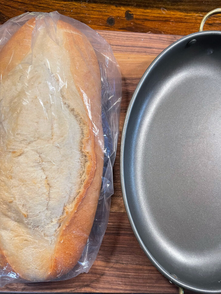 Loaf of bread and baking pan set out.