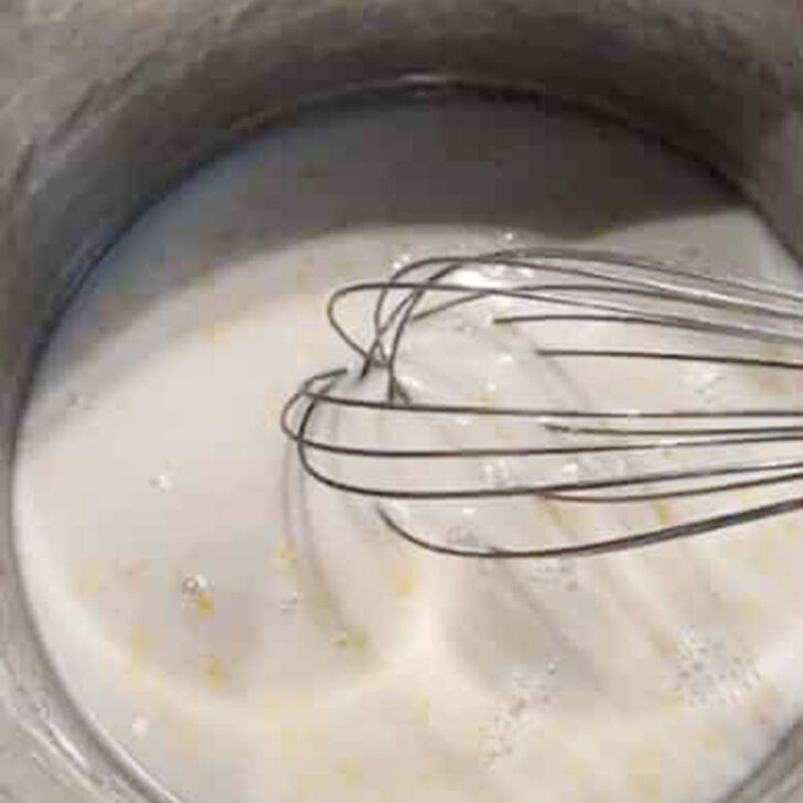 Cooking the pudding mixture in a saucepan.