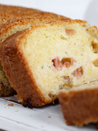 rhubarb loaf sliced on white board