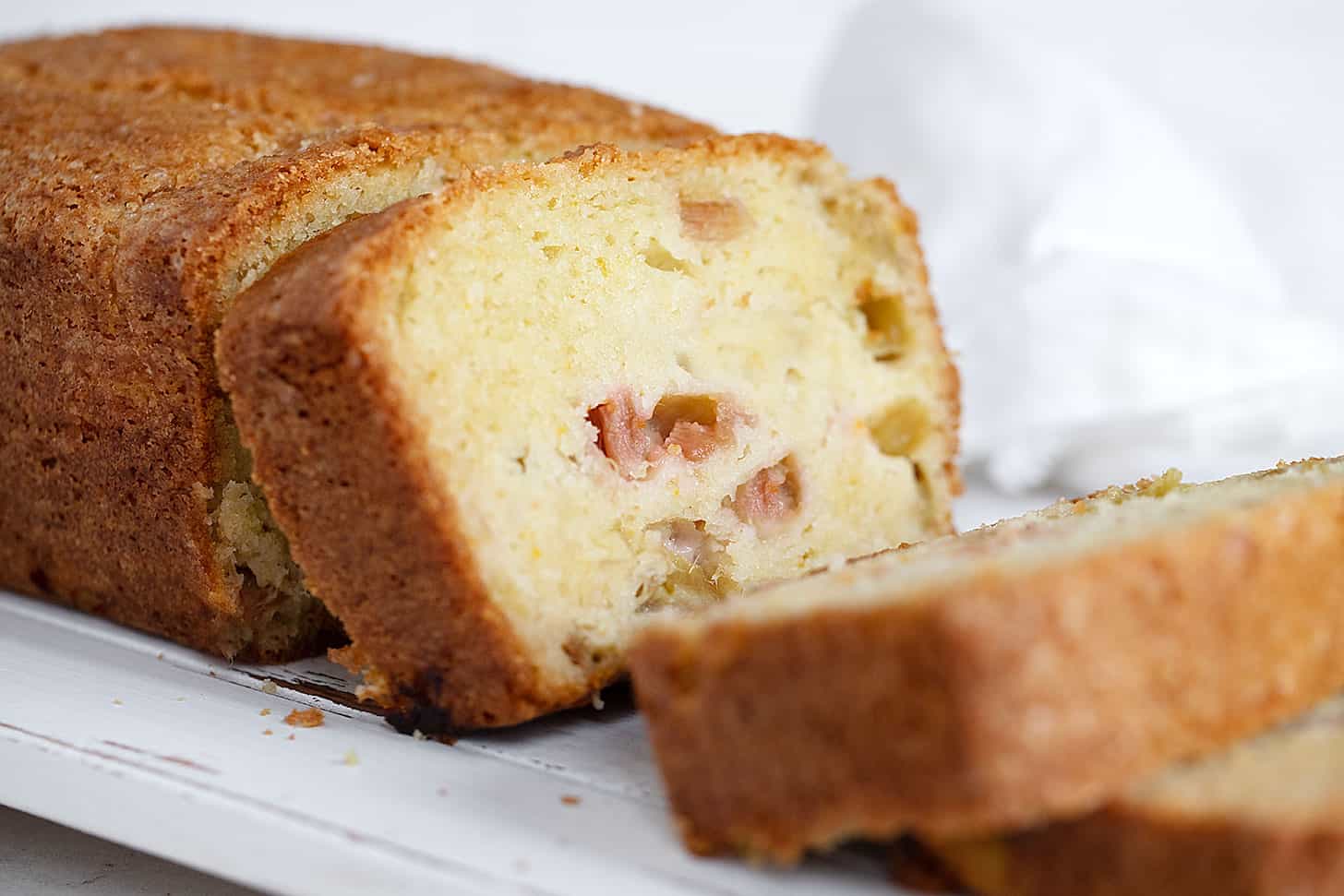 rhubarb loaf sliced on white board