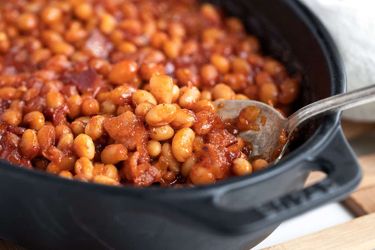 baked beans in baking dish with spoon
