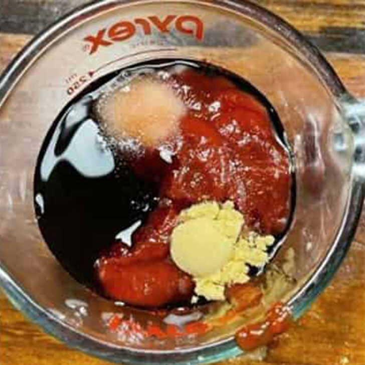 Sweet and sassy baked beans sauce ingredients in a measuring cup.