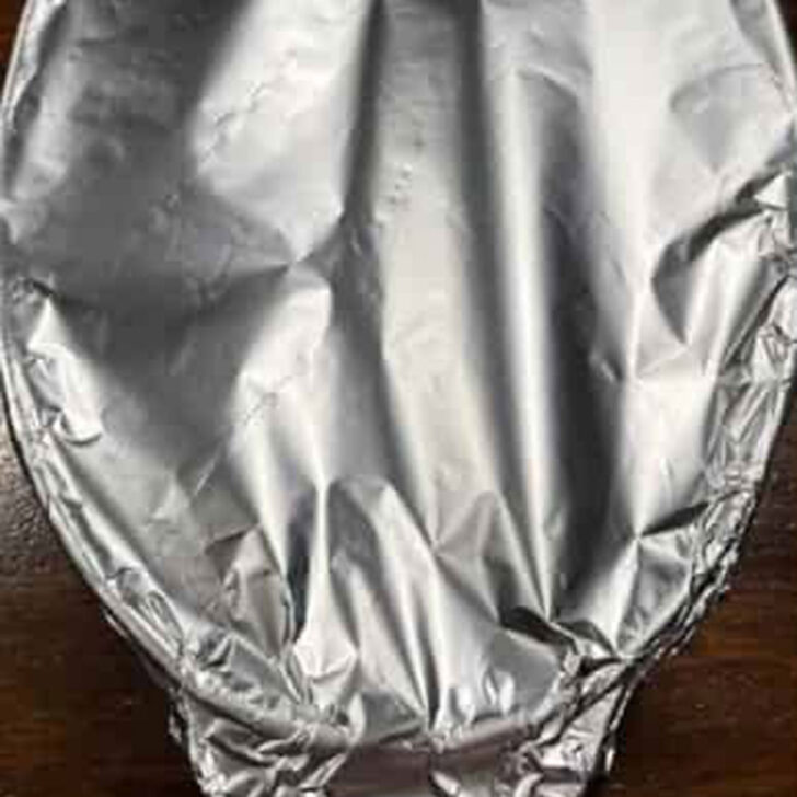 Casserole dish covered tightly with aluminum foil.