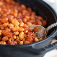 baked beans in baking dish with spoon