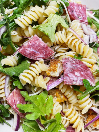 Pasta salad with salami in a bowl.