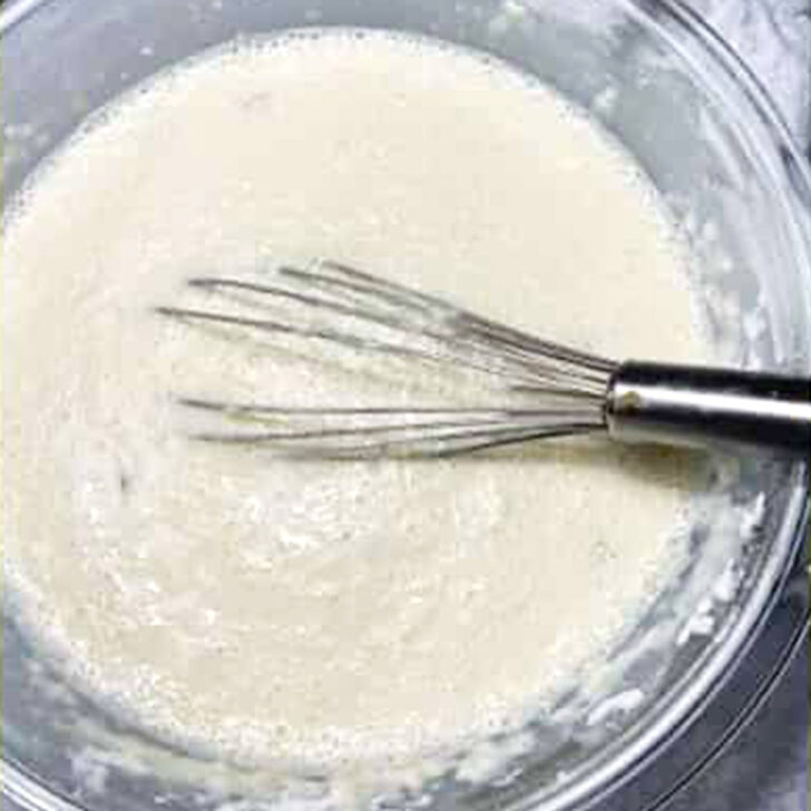 Prepared Dutch baby batter in a mixing bowl.
