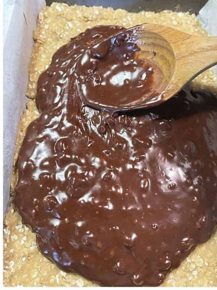 Spreading the chocolate filling on top of the base layer.