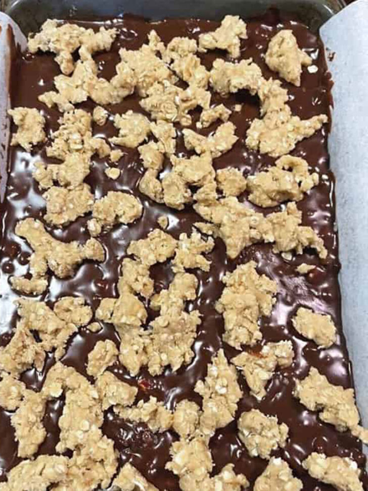 Dough bits scattered on top of the chocolate layer.