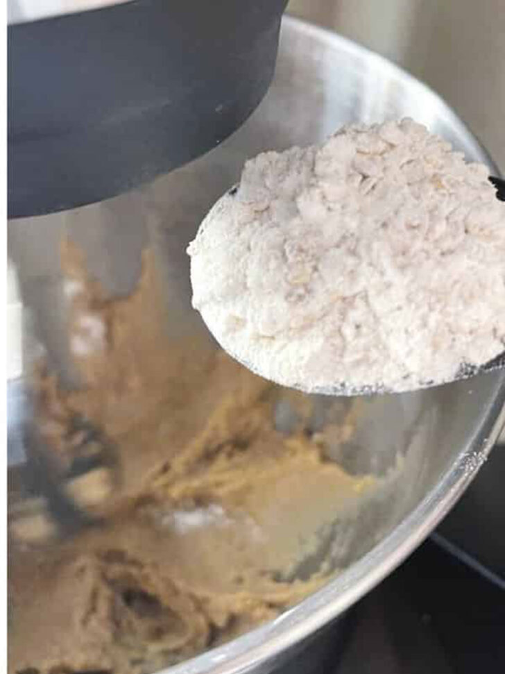 Adding the flour to the mixing bowl.