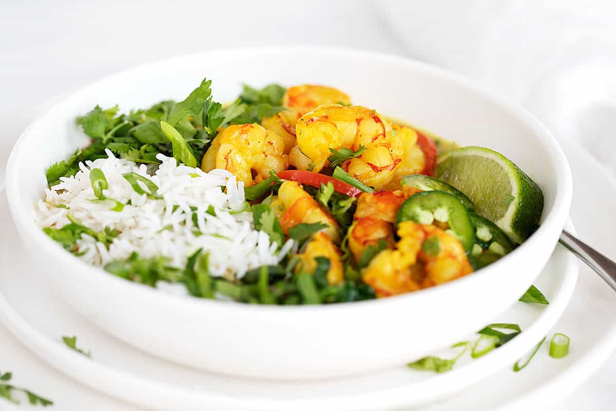 shrimp with coconut milk and rice in white bowl