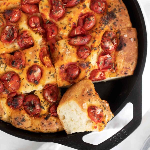 skillet focaccia sliced in cast iron skillet