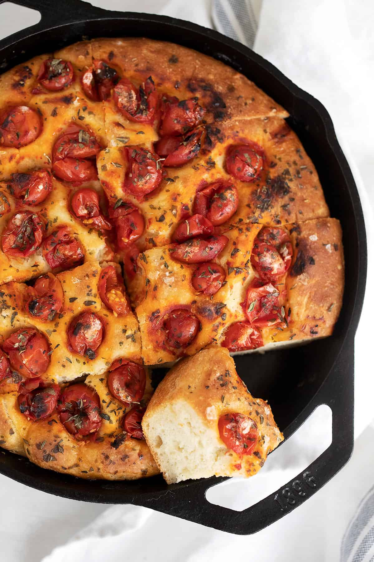 skillet focaccia sliced in cast iron skillet