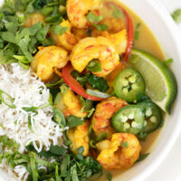 shrimp with coconut milk and rice in white bowl