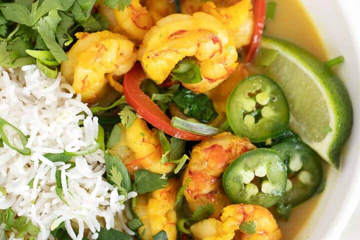 shrimp with coconut milk and rice in white bowl